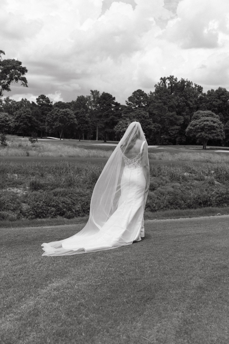 Bride’s veil catching the wind in black and white